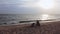 Siblings is playing and running on a summer beach with shadow silhouette sunset.