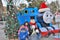 Siblings posing with thomas the train