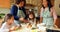 Siblings preparing food with family in kitchen 4k