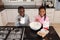 Siblings preparing food on a worktop in kitchen at home