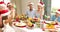 Siblings pulling a christmas cracker at the dinner table