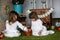 Siblings sisters in nightgowns playing with rabbit