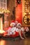 Siblings sisters in santa hats near fireplace on Christmas ligh