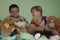 Siblings sitting in the middle of all her stuffed animals