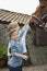 Siblings Stroking Horse Outside Stable