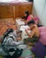 Siblings studying together, doing homework at home on the bed.