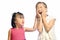 Siblings teasing, asian little girl pulling her sister\'s ear