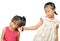 Siblings teasing, asian little girl pulling her sister\'s hair