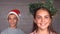 Siblings wearing garland and hat to celebrate christmas