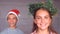 Siblings wearing garland and hat to celebrate christmas