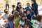 Sibuan, Malaysia - November 26, 2019: Visitors distributing snacks and goods to the Bajau Laut kids in their village