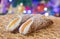 Sicilian cannolo with orange candied fruit with christmas lights as background