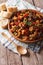 Sicilian cuisine: Caponata with aubergines close-up. Vertical, r