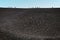 SICILY, ITALY - OCTOBER 1, 2018: People walking on the peak of Etna volcano. The biggest active mountain volcano in Europe