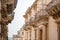 Sicily, Noto town the Baroque Wonder - UNESCO Heritage Site. Detail of Palazzo Nicolaci balcony, the maximum expression of the