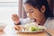 Sick asian child girl eating healthy food for lunch by herself while stay in private patient rooms in the hospital.