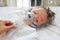 Sick baby boy applying inhale medication by inhalation mask to cure Respiratory Syncytial Virus RSV on patient bed at hospital
