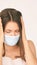 Sick beauty white girl with protective mask. Pandemic quarantine corona virus