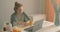 sick businesswoman eating tangerines working on project