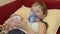 Sick child at childrens hospital plays in phone, girl ingaliruut inhaling steam treatment