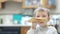 Sick child eating puff in the kitchen