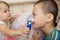 Sick children - baby girl and boy use nebulizer mask for inhalation, respiratory procedure by pneumonia or cough for child