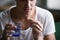 Sick depressed man holding glass of water taking pill, closeup