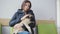 Sick dog pug with bandaged paw in line at veterinary clinic. Girl holds a sick dog in her arms