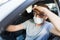 Sick driver with surgical face mask, covid-19 pandemic concept