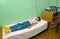 The sick girl adopts the procedure in a physiotherapeutic office