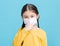 Sick Girl child in medical mask isolated on blue background