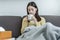 Sick, hurt or pain asian young woman, girl sore throat with glass, mug of warm water, headache have a fever, flu in weakness,