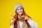 Sick illness redhaired woman good looking wearing knitted sweater and hat with scarf drinking hot tea cup with lemon and