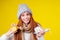 Sick illness redhaired woman wearing knitted sweater,hat with scarf choosing between natural lemon and ginger folk