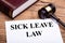 Sick Leave Law Documents With Book And Gavel