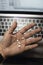 Sick male home office worker taking pills in front of his working space, during his working deadline night.