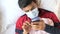 sick man in surgical face mask using smart phone,