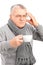 Sick mature man holding a cup of tea and gesturing headache