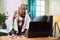 Sick Old man on video with to doctor on laptop at home - concept of Online Chat, telehealth, or tele counseling with Nurse or