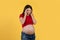 Sick Pregnant Woman Suffering From Headache While Standing  Over Yellow Background