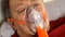 Sick senior man breathing through oxygen mask, rolling his eyes. Treatment of asthma, allergies, bronchitis, pneumonia.