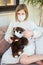 Sick toddler girl in medicine mask making vaccination her teddy bear with syringe