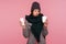 Sick unhealthy woman in scarf and hat holding in hands napkin and cup with hot tea, feeling chills