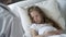 Sick weak girl lying in bed in hospital, doctor examining patient, healthcare