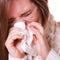 Sick woman girl with fever sneezing in tissue