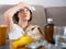 Sick woman with medicines lying on sofa