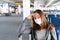 Sick young Asian woman with surgical mask face protection sitting at airport terminal. Health care and protection concept