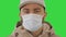 Sick young man handsome wearing medical mask on a Green Screen, Chroma Key.