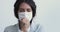 Sick young woman having pneumonia coughing wearing face mask