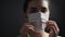 Sick young woman wearing protective medical mask